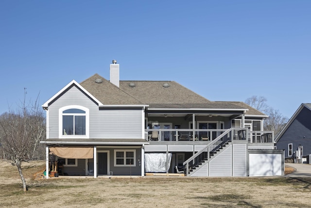 rear view of property featuring a yard and a sunroom