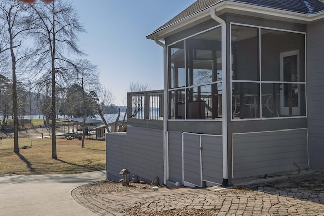 view of side of home featuring a sunroom