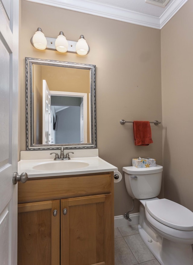 bathroom featuring tile patterned flooring, ornamental molding, vanity, and toilet