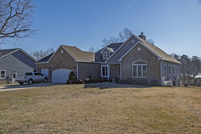 front of property with a garage, a front lawn, and central air condition unit