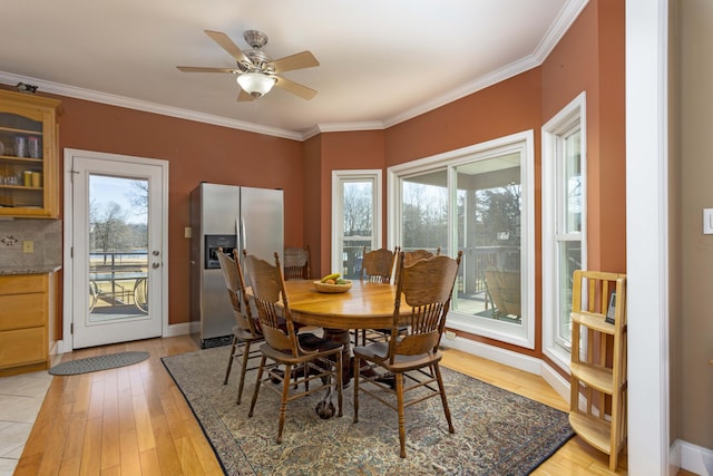 dining area featuring crown molding, ceiling fan, and light wood-type flooring