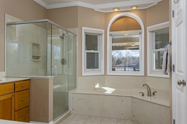 bathroom featuring plus walk in shower, tile patterned floors, crown molding, and vanity