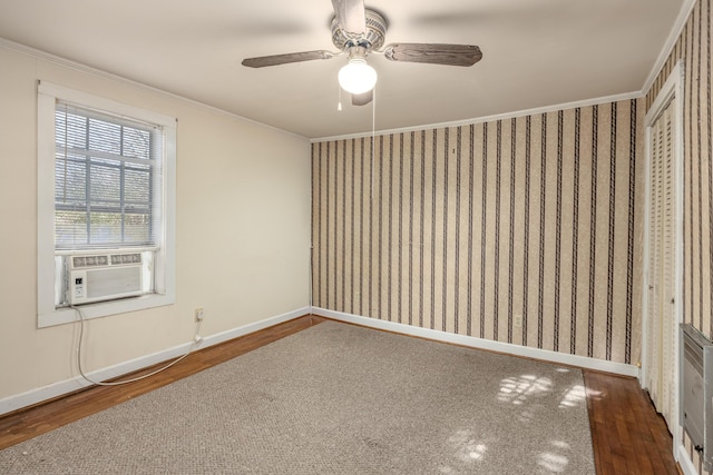 spare room with ceiling fan, crown molding, cooling unit, and dark hardwood / wood-style floors