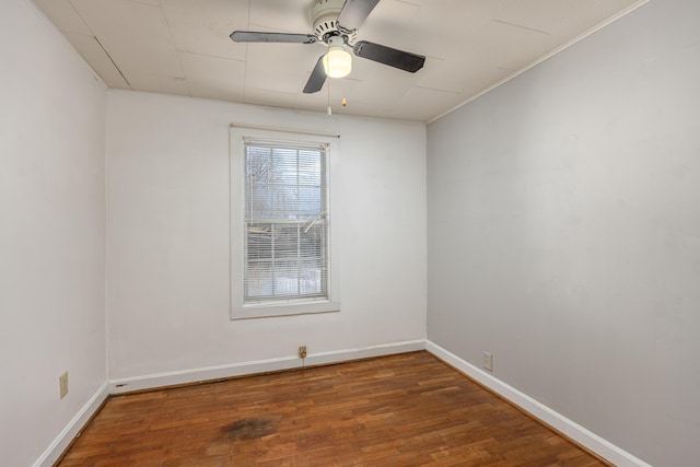 spare room with ceiling fan and dark wood-type flooring