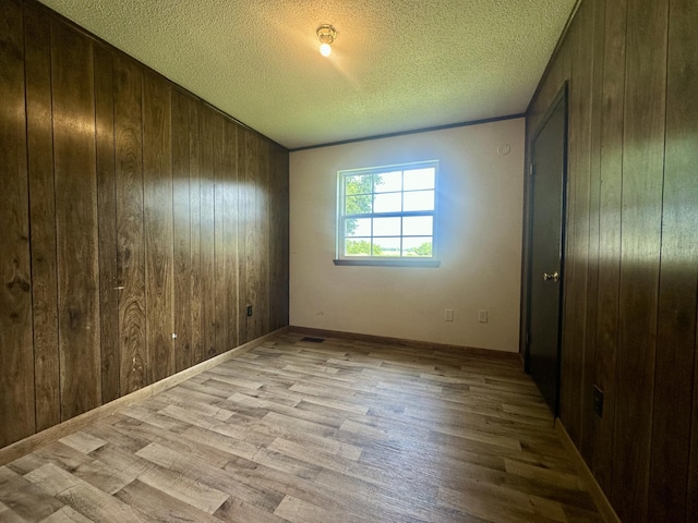175 Sunset Estates Ln, Dayton, TN 37321 - unfurnished bedroom featuring wooden walls, wood finished floors, and a textured ceiling