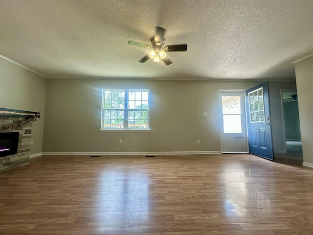 175 Sunset Estates Ln, Dayton, TN 37321 - unfurnished living room featuring a ceiling fan, a textured ceiling, healthy amount of natural light, wood finished floors, and a fireplace