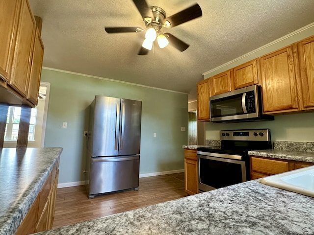 175 Sunset Estates Ln, Dayton, TN 37321 - kitchen with stainless steel appliances, a textured ceiling, ceiling fan, dark wood-type flooring, and brown cabinets