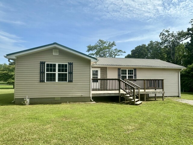 175 Sunset Estates Ln, Dayton, TN 37321 - rear view of property featuring a wooden deck, a lawn, and metal roof