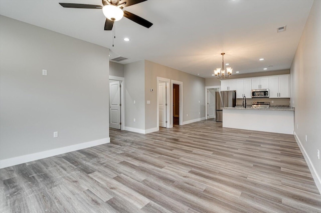 4470 Keith St NW Unit 501, Cleveland, TN 37312 - unfurnished living room featuring a chandelier, a ceiling fan, baseboards, light wood-style flooring, and recessed lighting