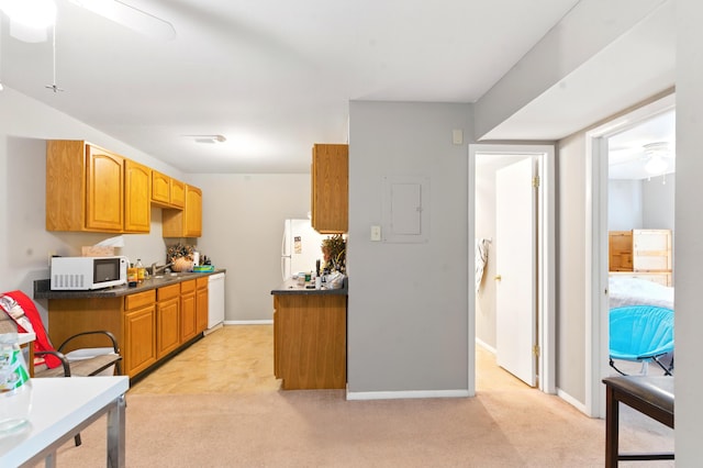 kitchen with white appliances, dark countertops, ceiling fan, and light carpet