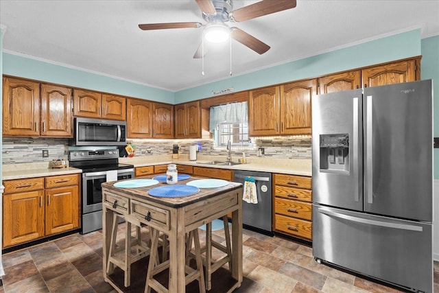 kitchen with a sink, stainless steel appliances, decorative backsplash, and brown cabinetry