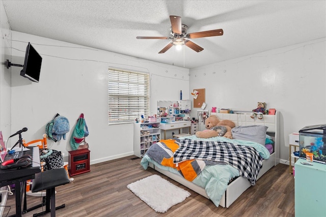 bedroom featuring baseboards, a textured ceiling, wood finished floors, and a ceiling fan