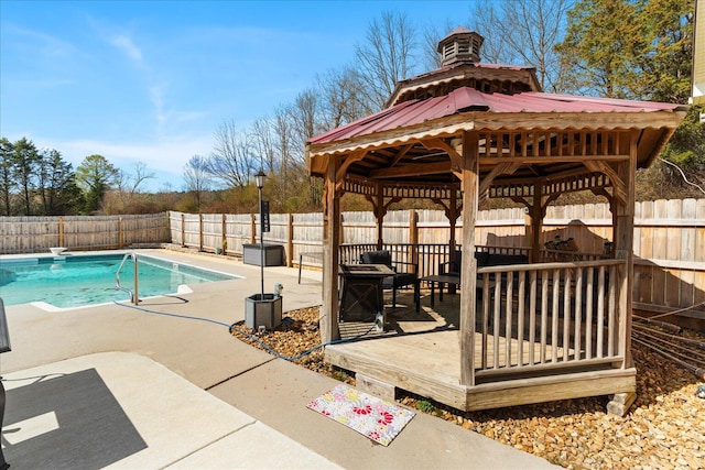 view of pool featuring a fenced in pool, a gazebo, a fenced backyard, a patio, and a diving board