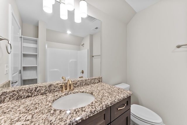 bathroom featuring a shower, visible vents, toilet, and vaulted ceiling