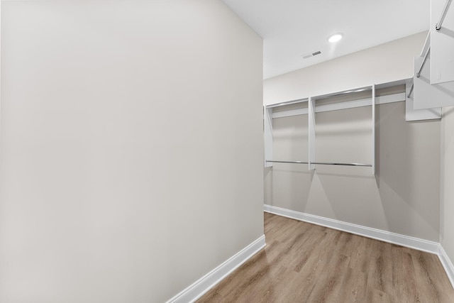 walk in closet featuring wood finished floors and visible vents