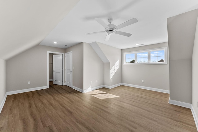 bonus room with vaulted ceiling, wood finished floors, baseboards, and ceiling fan