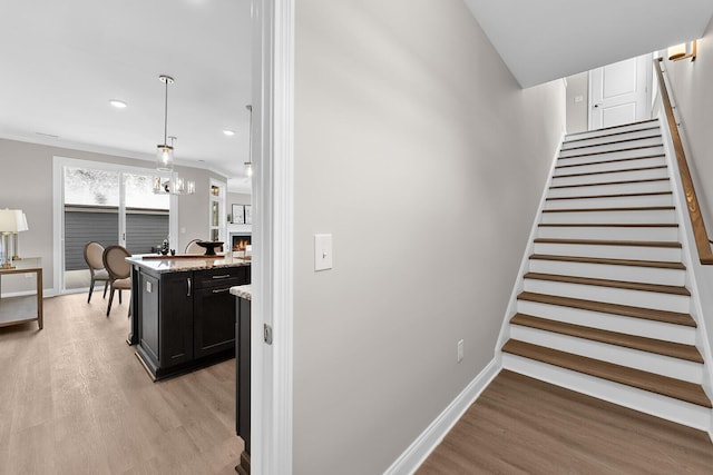 stairs featuring recessed lighting, wood finished floors, and baseboards