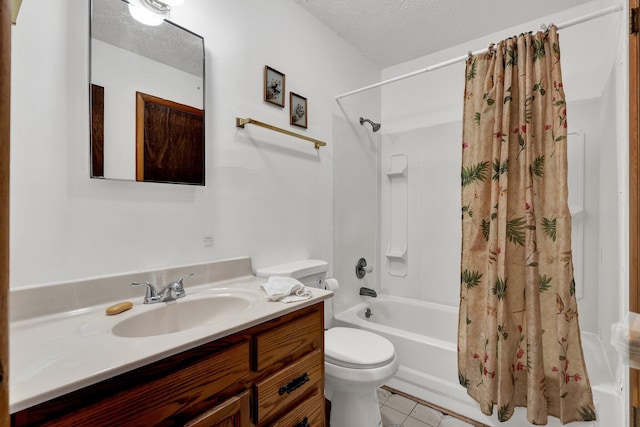 full bathroom with vanity, tile patterned flooring, toilet, shower / bath combo with shower curtain, and a textured ceiling