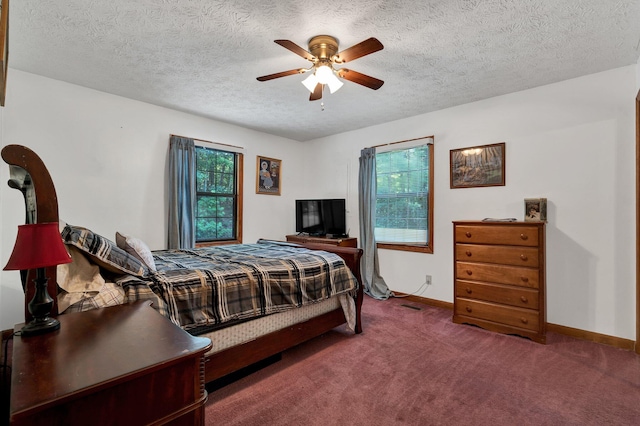 bedroom with carpet, ceiling fan, and a textured ceiling