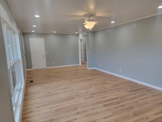 empty room featuring crown molding, ceiling fan, and light hardwood / wood-style floors