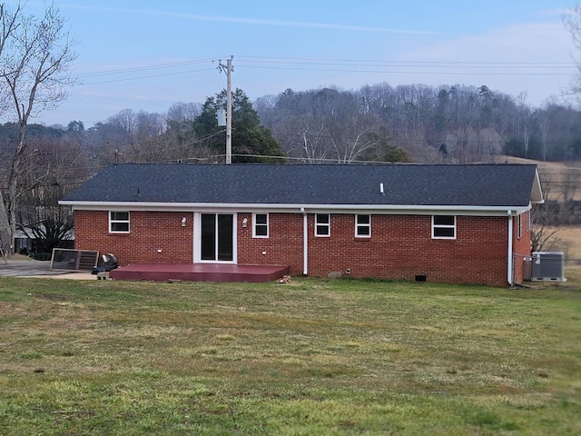 rear view of property featuring a yard, cooling unit, and a patio area