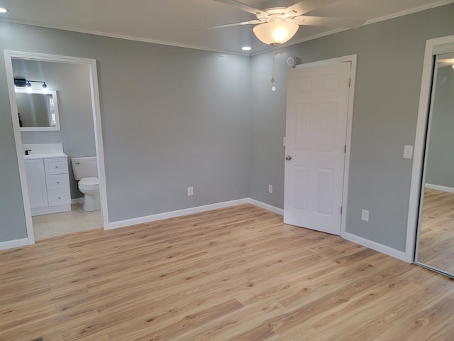 unfurnished bedroom featuring crown molding, ensuite bathroom, ceiling fan, and light hardwood / wood-style flooring