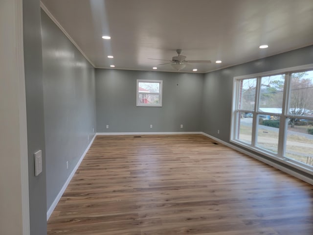 spare room with crown molding, ceiling fan, and hardwood / wood-style floors