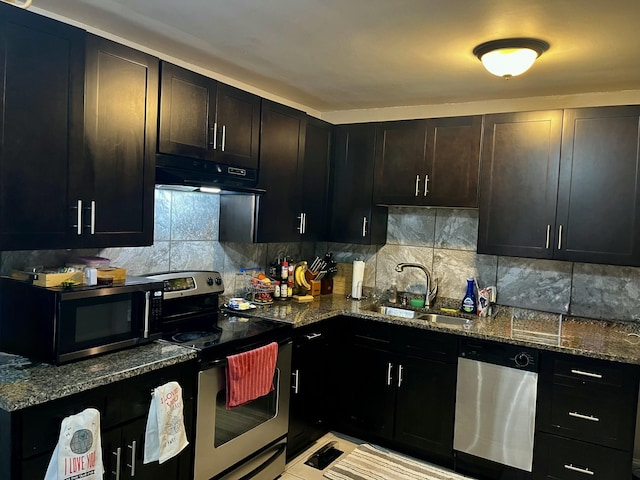 9 Edwards Ter, Chattanooga, TN 37412 - kitchen featuring appliances with stainless steel finishes, under cabinet range hood, dark stone counters, and tasteful backsplash