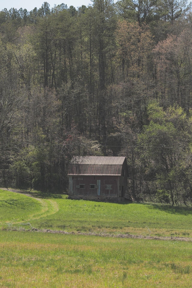 626 Brush Creek Rd, Copperhill, TN 37317 - view of front of house with a forest view, an outbuilding, and a front lawn