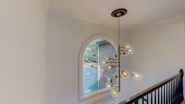 interior details with an inviting chandelier and crown molding