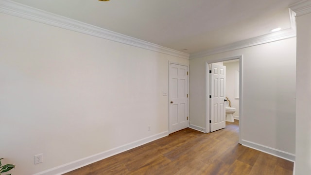 unfurnished room featuring hardwood / wood-style floors and ornamental molding