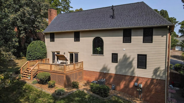 back of house featuring a deck