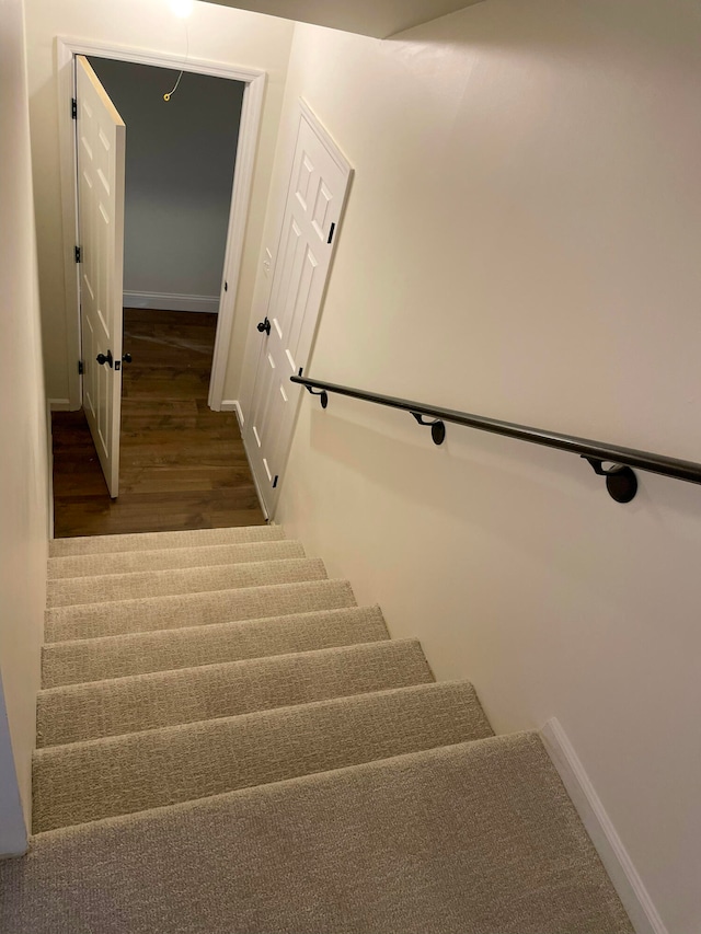 stairway featuring hardwood / wood-style floors