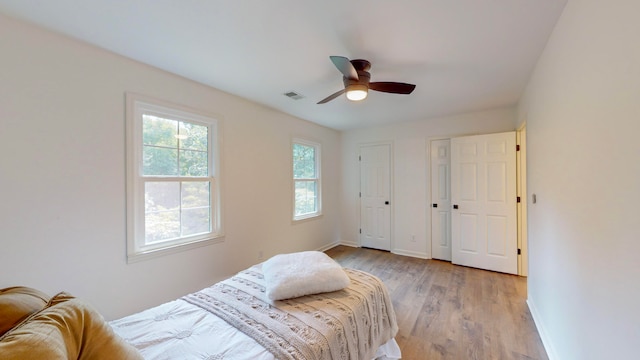 bedroom with light wood-type flooring and ceiling fan