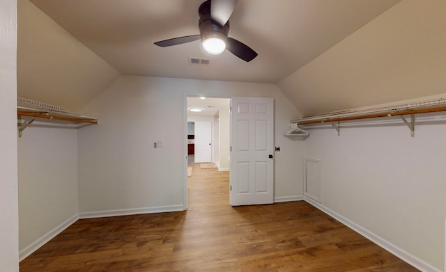 spacious closet with lofted ceiling, ceiling fan, and hardwood / wood-style flooring