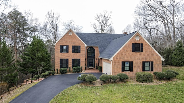 view of front of home featuring a garage and a front yard