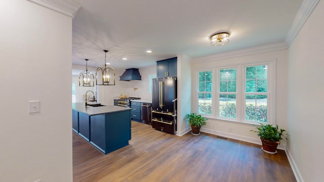 kitchen with dark hardwood / wood-style floors, blue cabinetry, custom range hood, pendant lighting, and sink