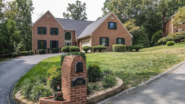 view of front of property with a front yard and a garage