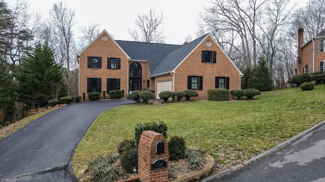 view of front of house with a front yard and a garage