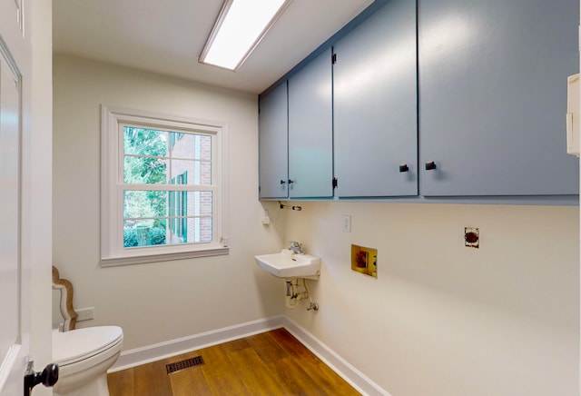 laundry room with sink, dark hardwood / wood-style floors, hookup for an electric dryer, and hookup for a washing machine