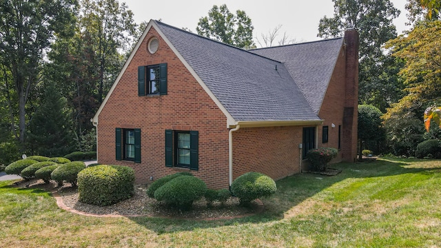 view of side of property with a yard