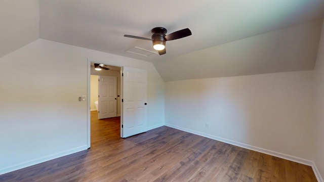 bonus room featuring vaulted ceiling and dark wood-type flooring