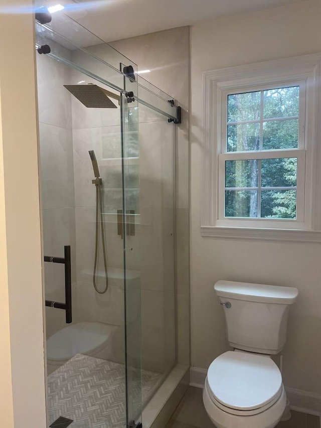 bathroom with an enclosed shower and toilet