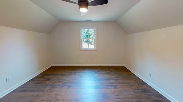 bonus room with ceiling fan, dark hardwood / wood-style flooring, and vaulted ceiling