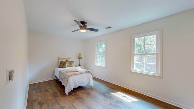 bedroom with ceiling fan and dark hardwood / wood-style floors