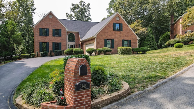 view of front of house with a front yard and a garage