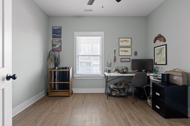 office space featuring light wood-style flooring, visible vents, and baseboards