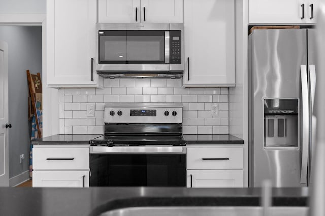 kitchen with stainless steel appliances, white cabinets, and tasteful backsplash