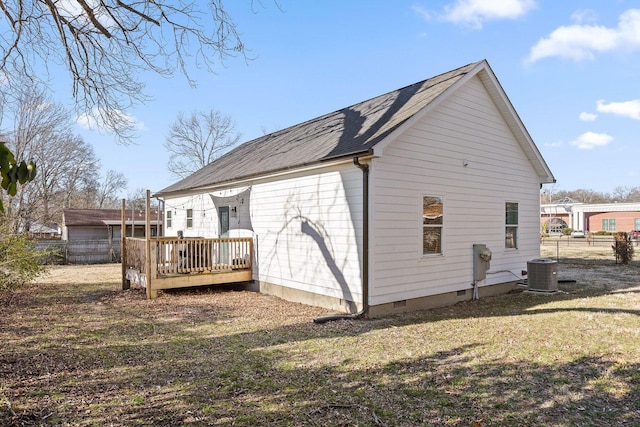 rear view of house with crawl space, a lawn, a deck, and fence