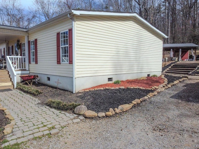 view of side of home with crawl space